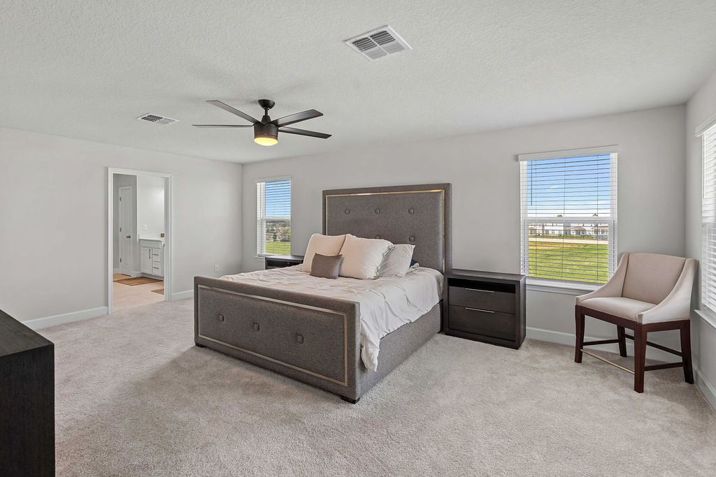 Spacious upstairs primary suite with green views